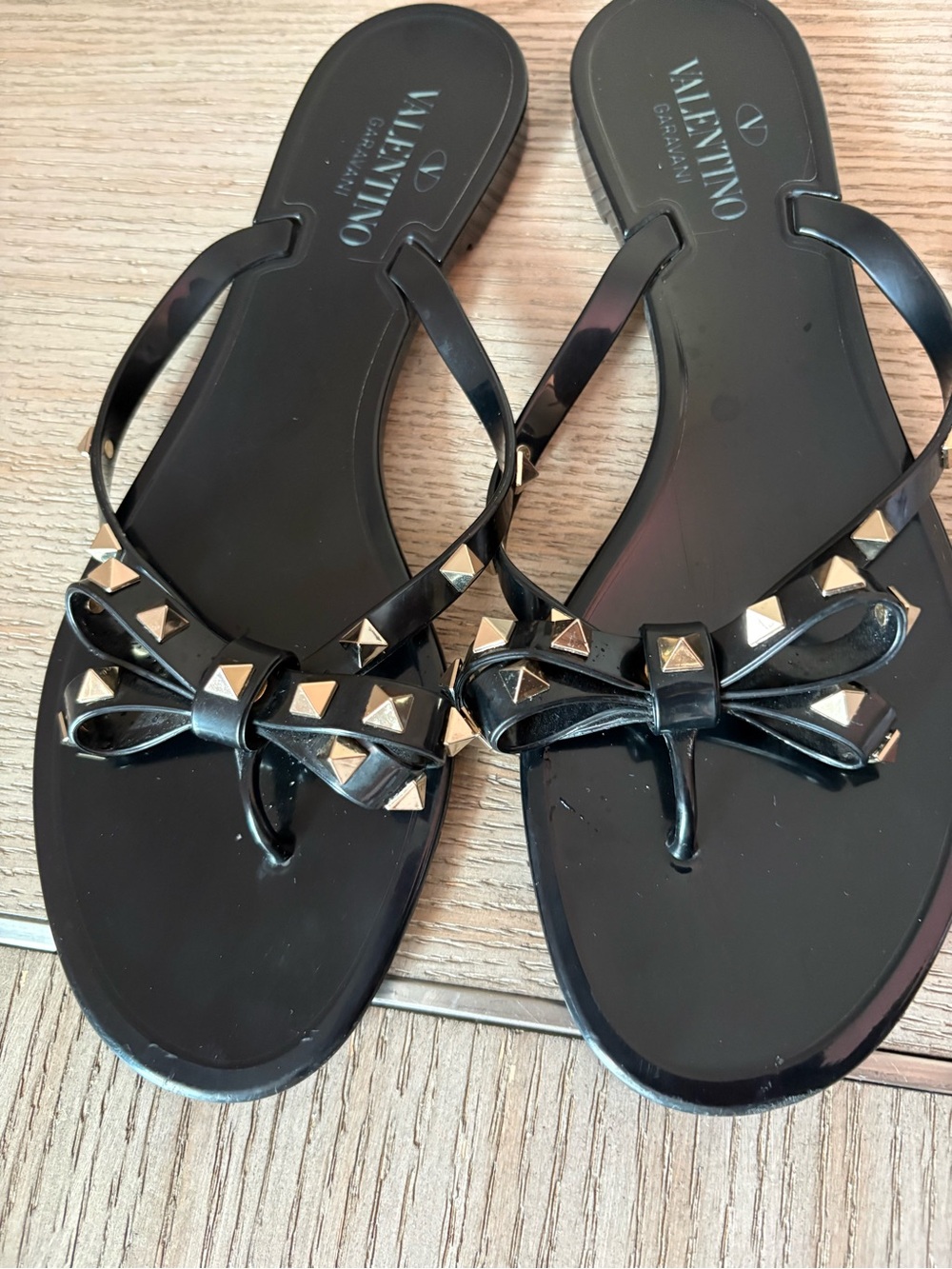 Valentino Garavani Black Jelly Bow Sandals with Gold Rockstuds